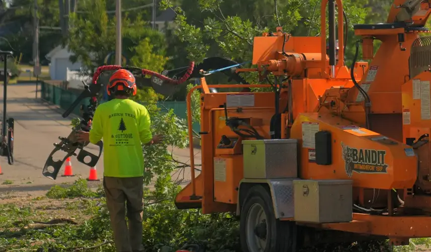 Team operating chipper for shrub trimming & removal services in Southeastern Wisconsin.